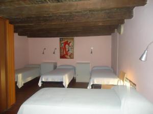 a room with four beds in a room at Protezione della Giovane - female hostel in Verona