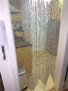 a shower with a glass door with a mirror at Beautiful Apartment with a stunning location in Poole