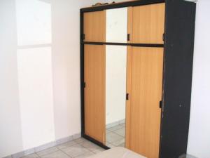 a closet with a wooden door in a room at Maison de 2 chambres avec terrasse amenagee a Bouillante a 2 km de la plage in Bouillante