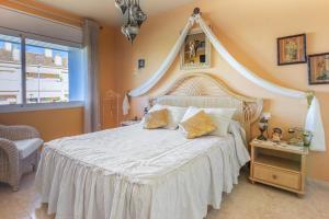 a bedroom with a large bed with a white bedspread at Modern villa with pool in Torredembarra - Sea view in Torredembarra