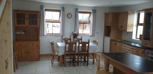 a kitchen with a table and chairs in it at Murphy's Irish farmhouse near Ballybunion in Ballybunion