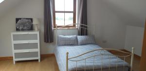 A bed or beds in a room at Murphy s Irish Farmhouse near Ballybunion