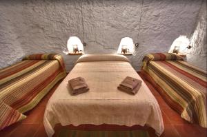 a room with two beds in a room with lights at One bedroom property with shared pool at Gorafe in Gorafe