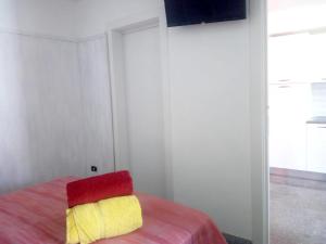 um quarto com uma almofada vermelha e amarela numa cama em One bedroom appartement with wifi at Montegiordano 9 km away from the beach em Montegiordano