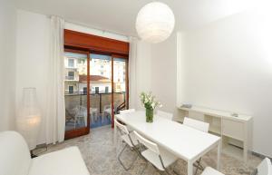 a white dining room with a white table and chairs at Spacious Apartment in Maiori with Sea View - 110 m² in Maiori