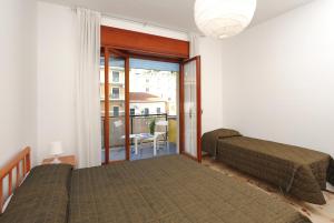 a bedroom with two beds and a balcony at Spacious Apartment in Maiori with Sea View - 110 m² in Maiori