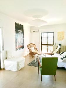 a living room with a couch and a table at Comfortable Apartment Tavira + Terrace in Tavira
