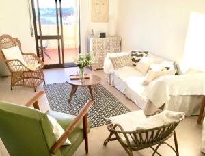 a living room with a couch and chairs and a table at Comfortable Apartment Tavira + Terrace in Tavira