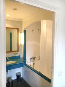 Un baño con bañera, lavabo y espejo. en Appartement cosy à Saint-André-des-Eaux de 47 m² avec jardin, en Saint-André-des-Eaux