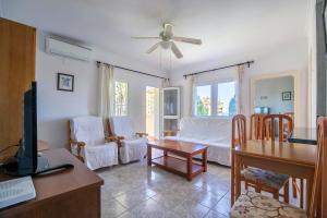 a living room with a couch and a table at Sea View Apartment in Benalmádena, Shared Pool in Benalmádena