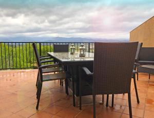 a table and chairs on a balcony with a view at 4 bedrooms house with terrace and wifi at Cretas in Cretas