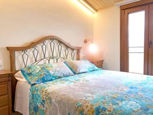 a bedroom with a bed with a floral bedspread at 4 bedrooms house with terrace and wifi at Cretas in Cretas