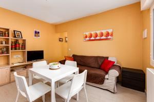 a living room with a couch and a table at 2 bedrooms villa with private pool enclosed garden and wifi at Torrevieja 5 km away from the beach in La Mata