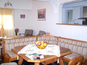 a living room with a bowl of fruit on a table at 3 bedrooms house with enclosed garden and wifi at Kakovatos in Kakóvatos