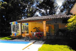 una pequeña casa con una piscina frente a ella en Appartement de 2 chambres avec piscine partagee jardin clos et wifi a Lancon provence, en Lançon-Provence