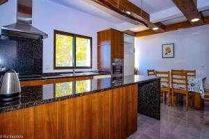a kitchen with a counter top and a dining room at 3 bedrooms house with shared pool garden and wifi at Monchique in Monchique