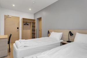 Postel nebo postele na pokoji v ubytování Hotel Muli