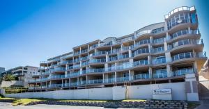 a large apartment building with balconies on a street at Santorini 105A in Margate