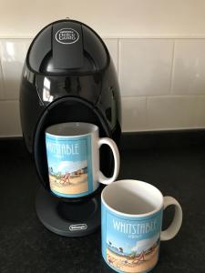 a coffee maker and two coffee cups on a counter at 1 Bed Flat Sleeps 4 Free Parking Balcony in Whitstable +33 photos
