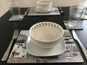 a black table with a bowl and plates and forks at 1 Bed Flat Sleeps 4 Free Parking Balcony in Whitstable