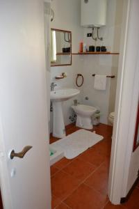 a bathroom with a sink and a toilet at da lina in Porto Santo Stefano +5 photos