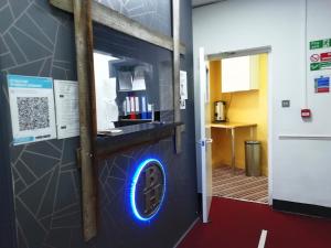 a wall with a blue sign on it next to a door at The Bank in Barking