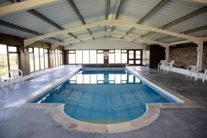 a large swimming pool in a large building at Rose Cottage in Bude
