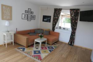 a living room with a couch and a table at Apartment Erdgeschoss in Hohenlockstedt