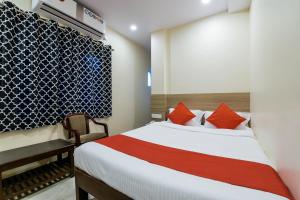 a bedroom with a bed and a chair in a room at THE ELITE INN in Visakhapatnam