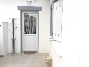 a bathroom with white walls and a white door at Maison de 2 chambres avec jardin clos et wifi a Saint Pierre d'Oleron a 1 km de la plage in Saint-Pierre-dʼOléron