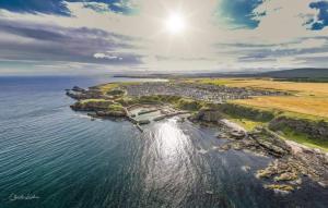 an aerial view of a small island in the water at 4-Bed Cottage in Portknockie Near Cullen Moray in Portknockie