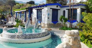 a pool with a water slide in a yard at Casa completa para parejas jacuzzi piscina y wifi cerca al Caminito del Rey Málaga España in Alora