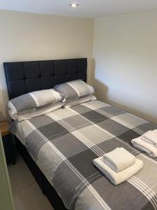 a bed with two towels on top of it at The Canteen Beautiful 1-Bed Apartment in Keswick in Threlkeld