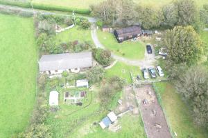 an aerial view of a farm with a barn and vehicles at Inviting 2-Bed Cottage in Newcastle Emlyn in Newcastle Emlyn