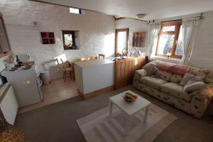 a living room with a couch and a kitchen at Inviting 2-Bed Cottage in Newcastle Emlyn in Newcastle Emlyn