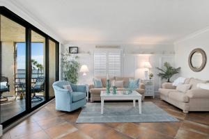 a living room with a couch and a table at Riverside Club E201 in Marco Island +21 photos