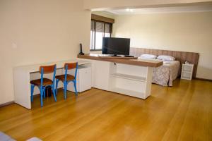 TV a/nebo společenská místnost v ubytování Hotel Letto Caxias