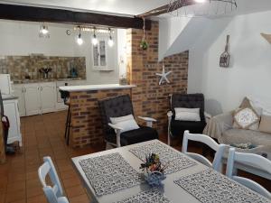 a kitchen and a living room with a table and chairs at Les Flots de St Val in Saint-Valéry-sur-Somme