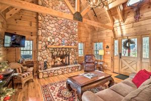 a living room with a fireplace in a log cabin at Private Sapphire Valley Resort Cabin with MTN Views! in Sapphire