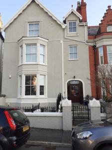 a house with a car parked in front of it at Modern 2nd floor 1 bed apartment in the heart of in Llandudno