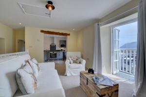 a living room with a white couch and a large window at Superb Sea View Apartment in Lynmouth