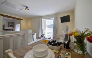 a kitchen and dining room with a table and chairs at Superb Sea View Apartment in Lynmouth