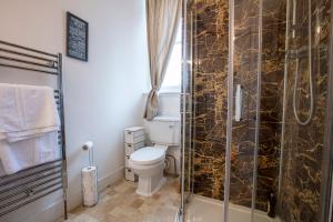 a bathroom with a toilet and a glass shower at Newton Manor House - Luxury Retreat Sleeps 13 in Fife +39 photos