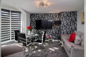 a living room with a couch and a table at New Luxury Seaview Apt2 Free Parking Special Deal in Blackpool
