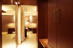 a hallway leading to a room with a dining room at Celesta Hotel - Kolkata in Kolkata