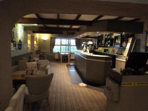 a restaurant with couches and a bar in a room at The Liscawn in Torpoint