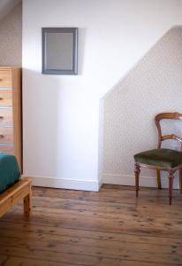 a bedroom with a chair and a stair case at Lavender House Weymouth in Weymouth