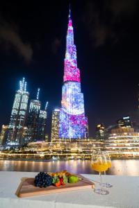 a night scene with lights and lights on a city street at Durrani Homes - Heaven On Earth- Burj Khalifa Fireworks in Dubai