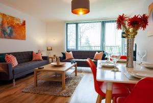 a living room with a couch and a table at ByEvo 5 Brabloch - perfect for contractors - Close to GLA in Paisley