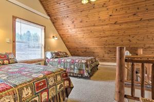 a bedroom with two beds and a wooden wall at Scenic Hill City Cabin Hiking and ATV Trail Access in Hill City